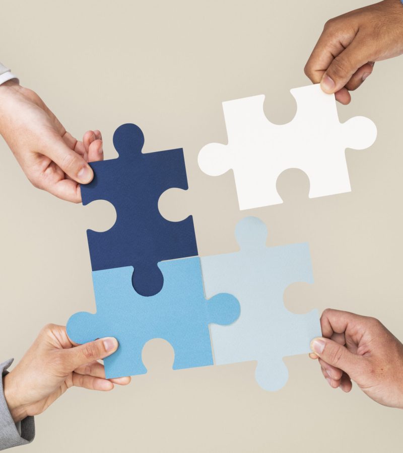 Hands holding puzzle business problem solving concept